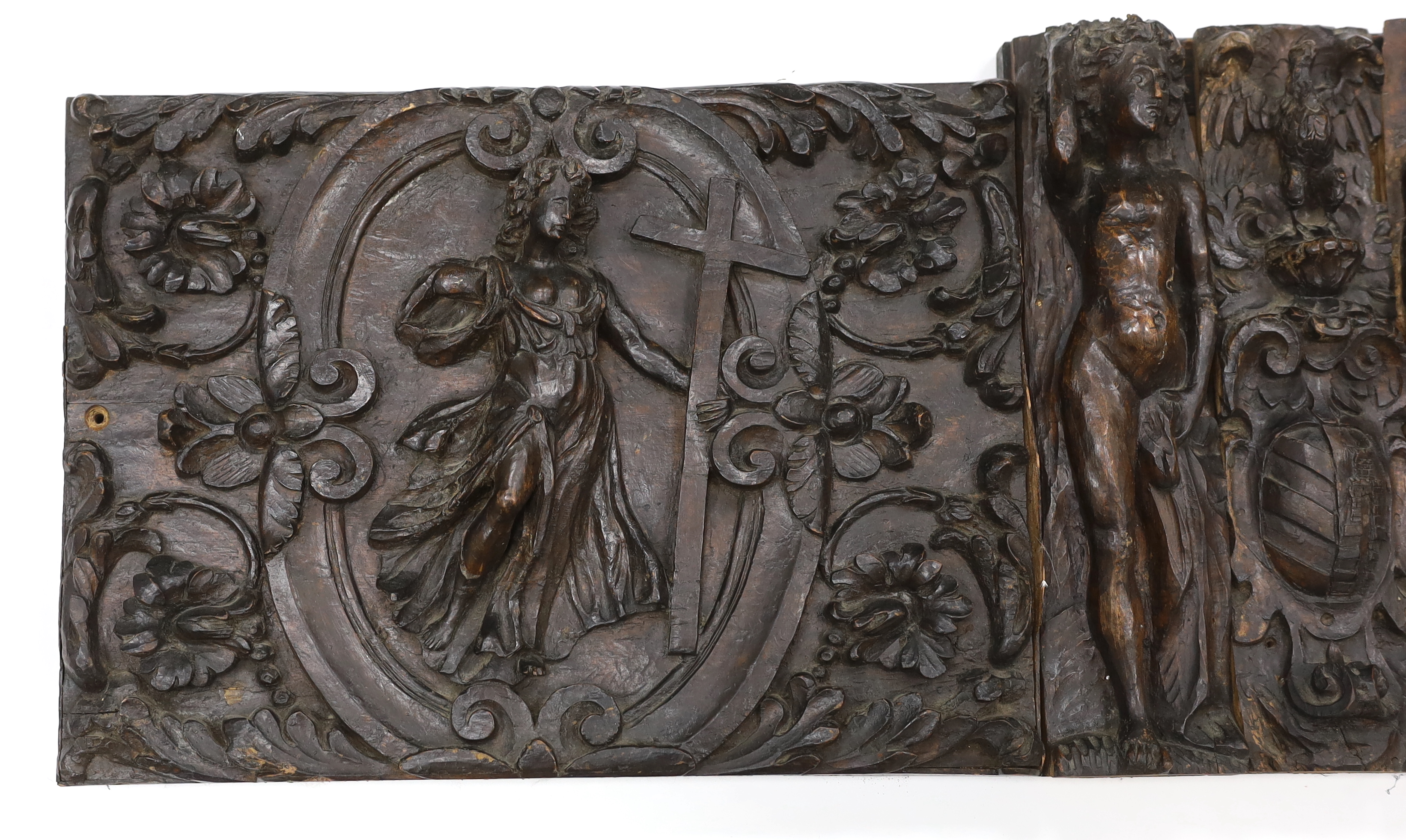 A 17th century French carved walnut triptych panel, 121cm wide, 37cm high